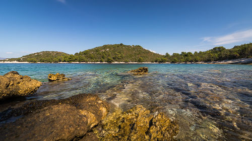 Scenic view of sea against clear blue sky