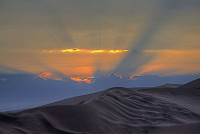 Scenic view of desert against sky during sunset