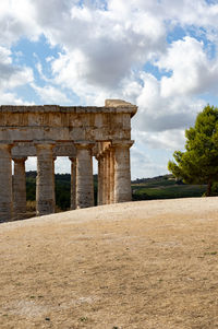 Old ruins of temple against cloudy sky