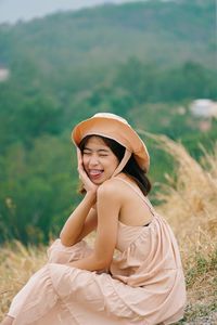 Side view of a smiling young woman