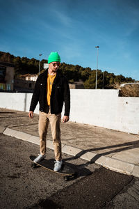 Full length of man standing on road against sky