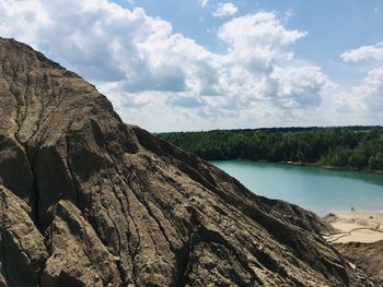 Scenic view of rock formation amidst trees against sky