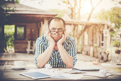 Man sitting outdoors at table