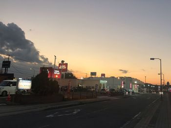 City street against sky during sunset