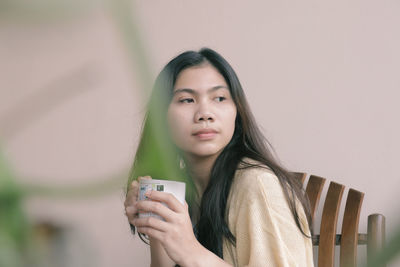 Portrait of young woman drinking coffee to take a break