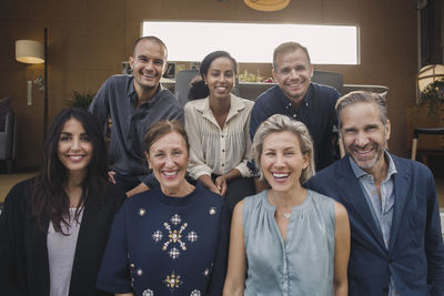 Portrait of smiling multi-ethnic business people against portable office truck