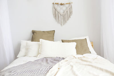 White curtain on bed against wall at home