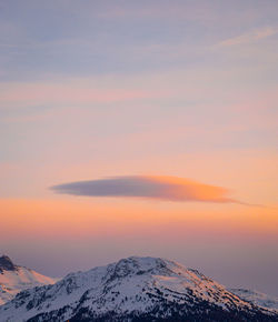 Scenic view of snow covered mountains against sky during sunset