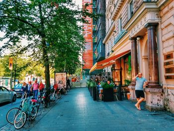 People on street amidst buildings in city