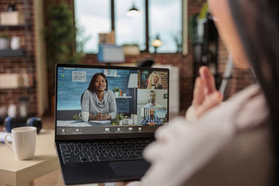 Businesswoman having video conference through laptop at home