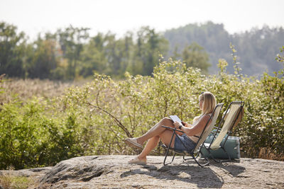 Woman reading book at summer