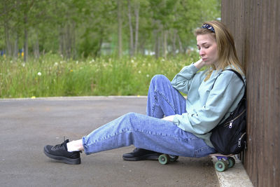 Young woman sitting on road