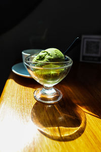 Close-up of green tea ice cream in glass bowl on table