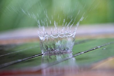Close-up of water splashing on table 