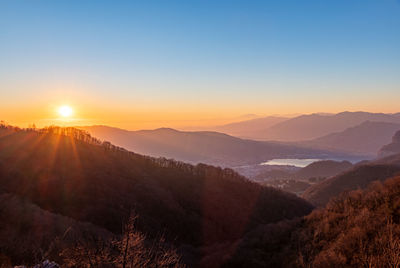 Scenic view of mountains against sky during sunset