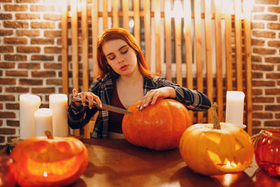 Portrait of woman holding pumpkin