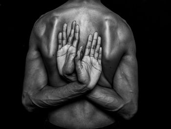 Close-up of human hands against black background