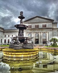 Fountain against cloudy sky