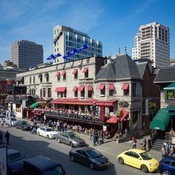 View of city street and buildings against sky