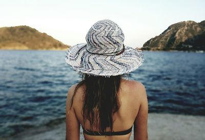 Rear view of woman standing on beach