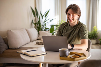 Young woman using laptop at home