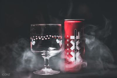 Close-up of wineglass on table against black background