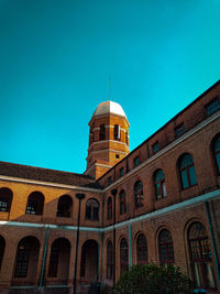 Low angle view of building against blue sky