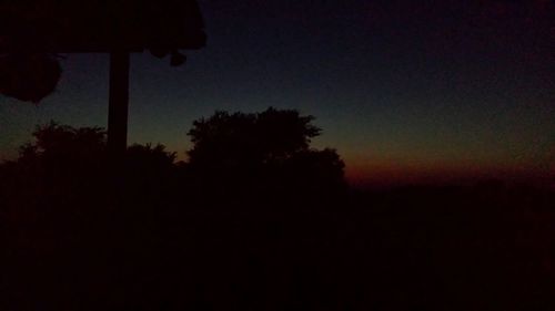 Silhouette of trees against sky at sunset