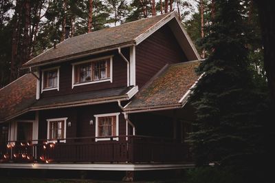 Low angle view of house and trees against sky