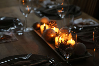 High angle view of lit candles on table