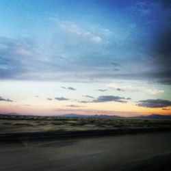 Scenic view of landscape against sky at sunset