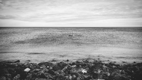 Scenic view of sea against cloudy sky