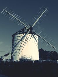 Low angle view of traditional windmill against clear sky