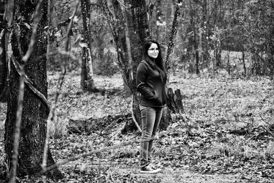 Full length of woman standing in forest