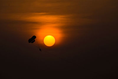Low angle view of sun shining in sky during sunset