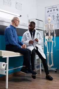 Doctor talking with patient in medical clinic