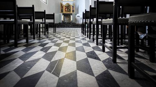 Empty chairs and tables in building