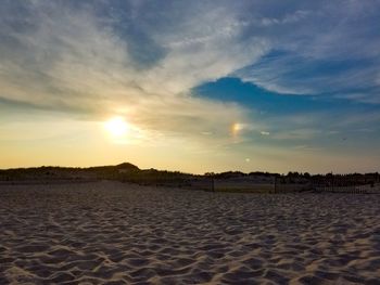 Scenic view of beach against sky during sunset