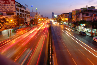 Light trails on road in city at night