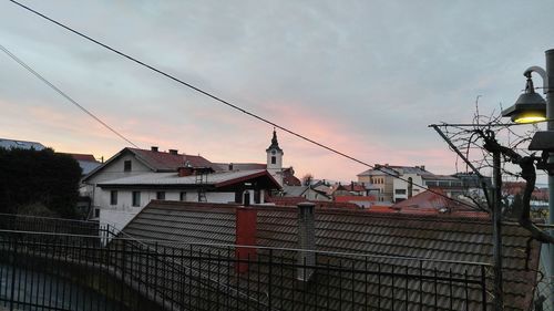 Buildings against cloudy sky