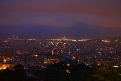 Aerial view of city lit up at night