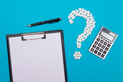 High angle view of information sign on table against blue background