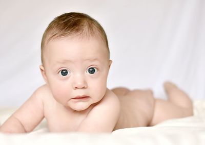 Portrait of cute baby girl in bed