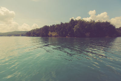 Scenic view of lake against cloudy sky