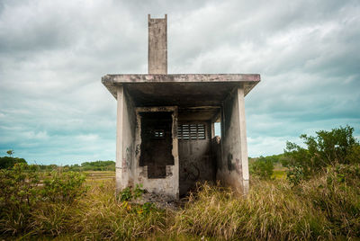 Abandoned built structure on field against sky