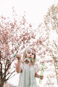 Blowing bubbles in the cherry blossoms
