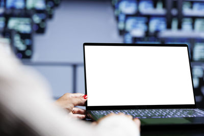 Midsection of woman using laptop on table