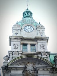 Low angle view of clock against the sky