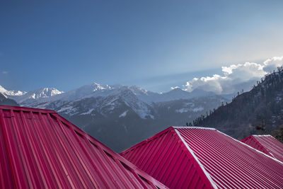 Scenic view of snowcapped mountains against blue sky