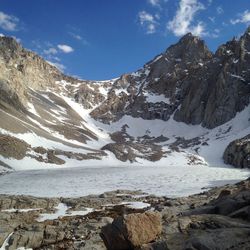 Snowed rocky landscape against blue sky